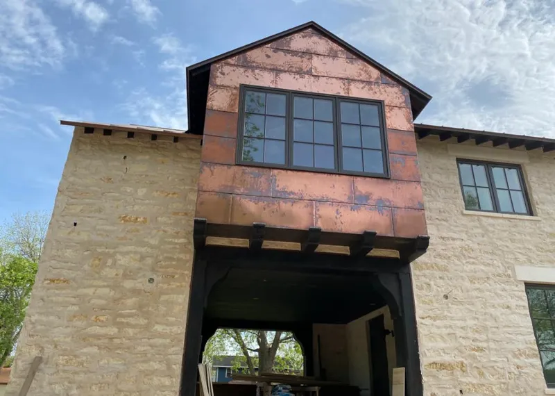 Copper metal panel facade on a stone building for Skylight Installation in Noblesville